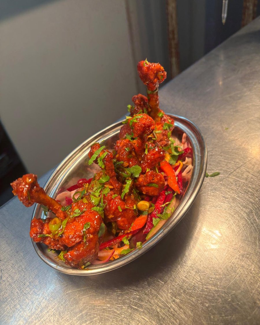 Chicken lollipops in a chilli glaze, on a bed of pickled slaw