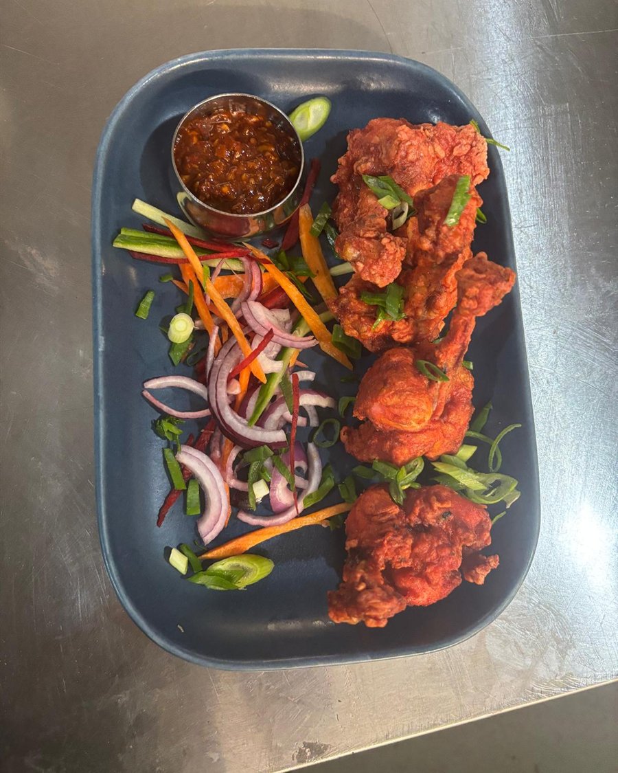 Fried chicken with a chilli dipping sauce and shredded salad
